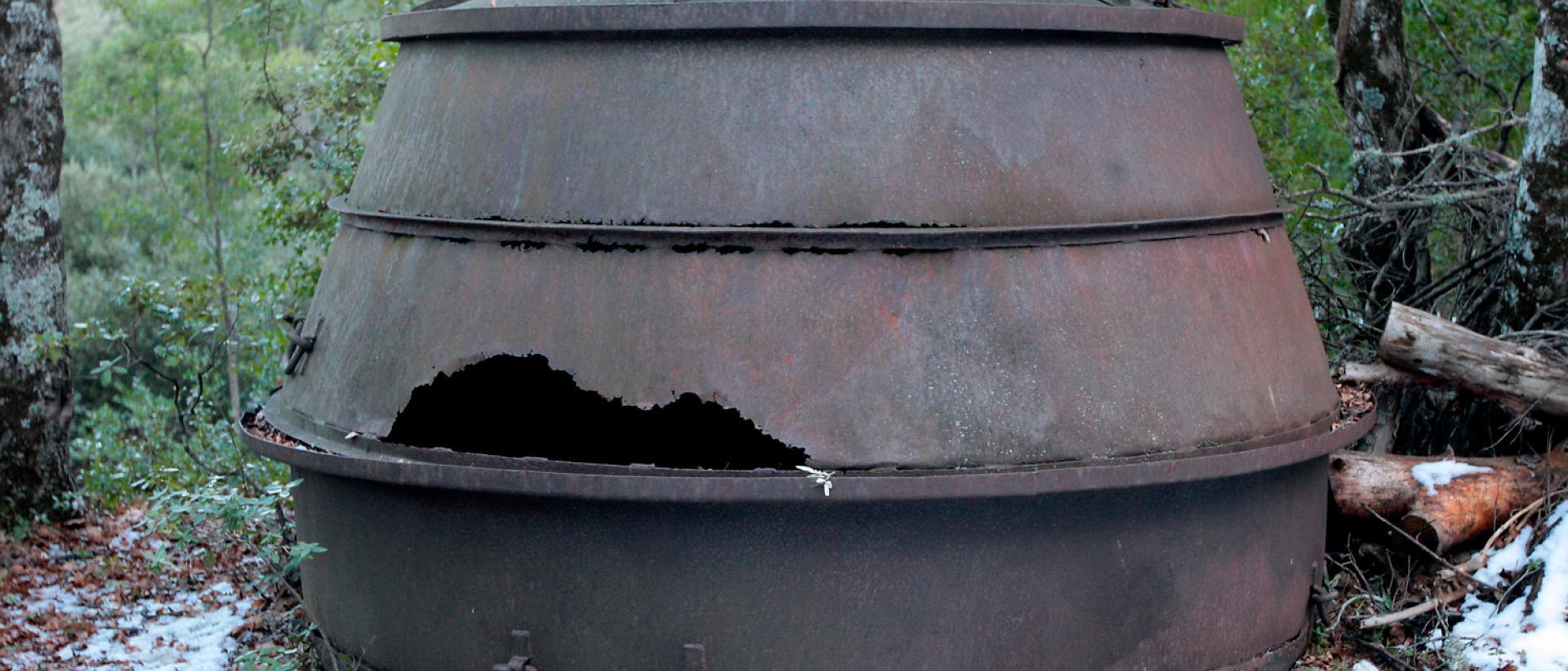 grand chaudron rouillé surmonté d'un couvercle attaqué par la rouille, en pleine nature - Agrandir l'image, fenêtre modale