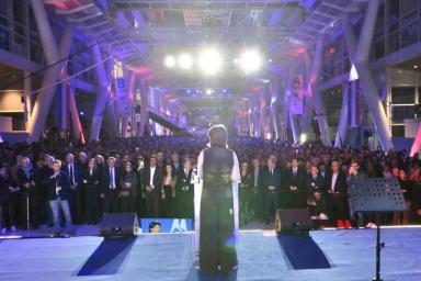 Martine Vassal vue de dos sur scène face à une foule nombreuse dans un grand hall éclairé